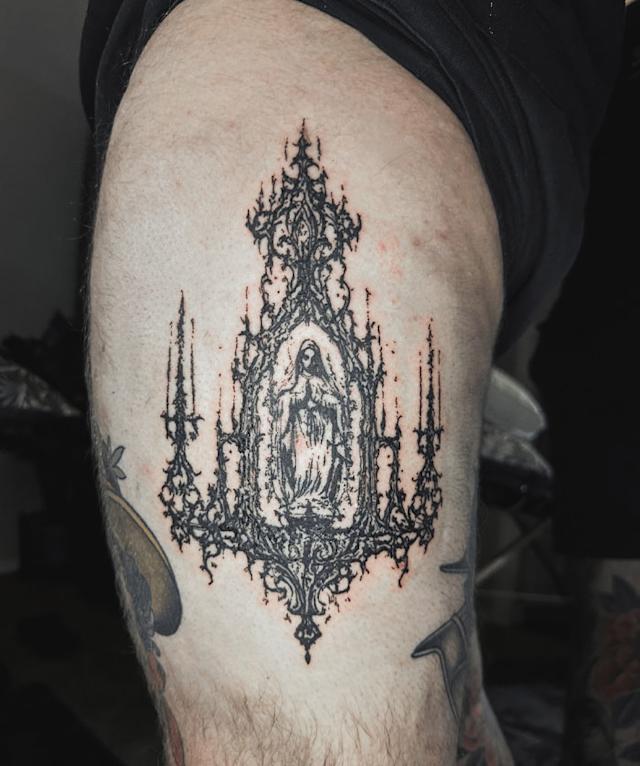 tattooed arm with an otherworldly structure