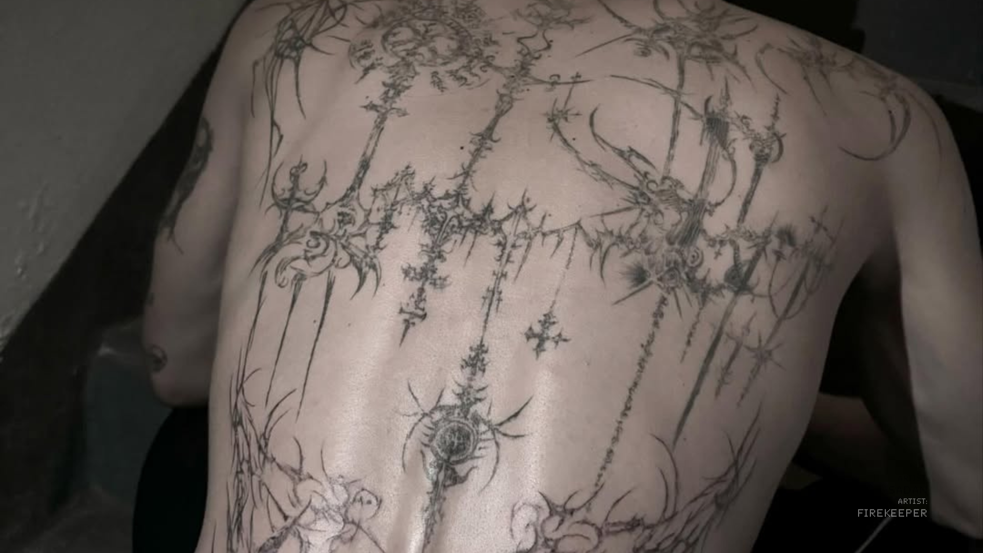 The back of someone with a large and complex tattoo
